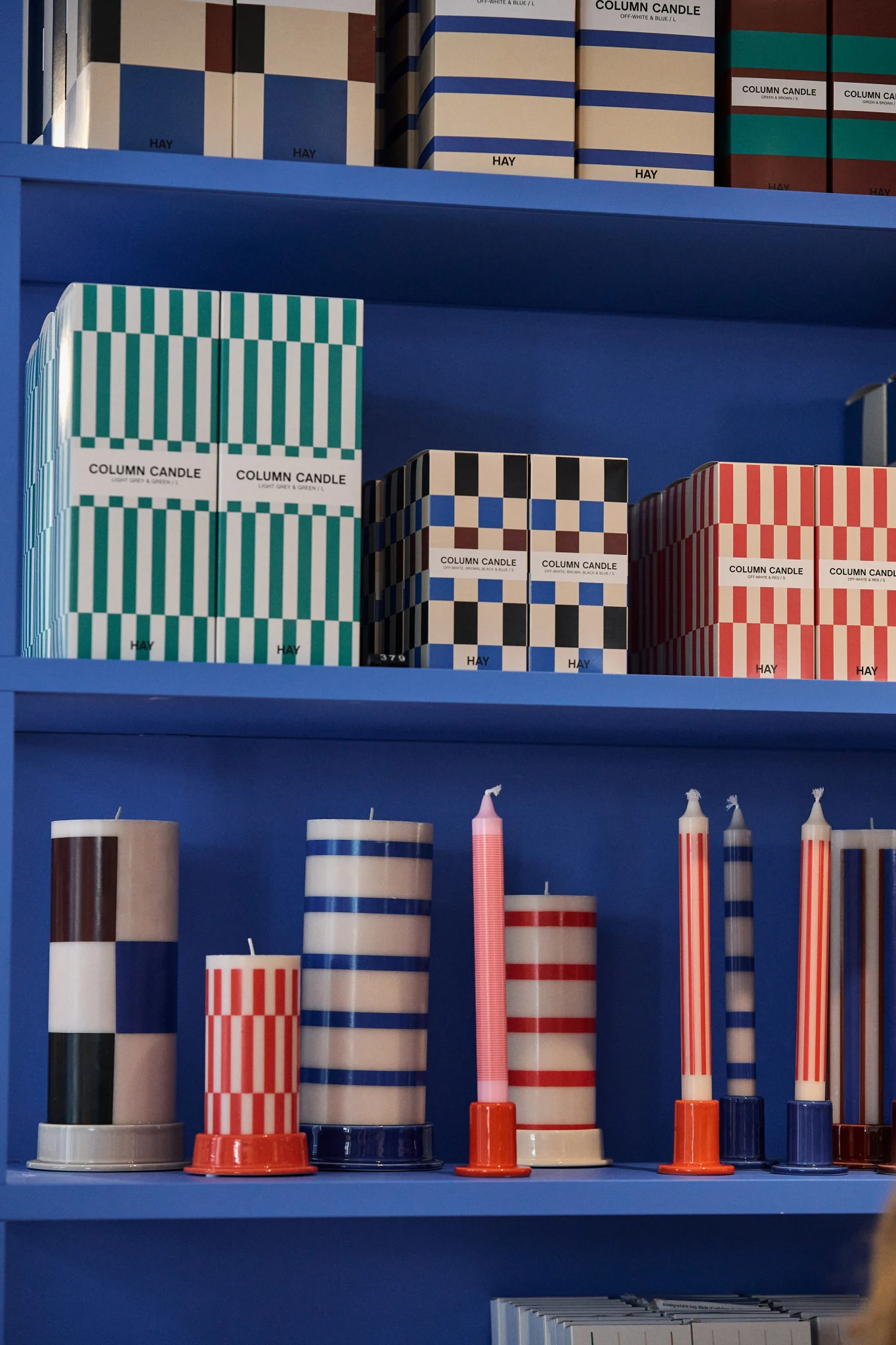 Stop number 1 on the Copenhagen city guide: HAY house. Here you see the chunky HAY striped candles on a blue shelf.