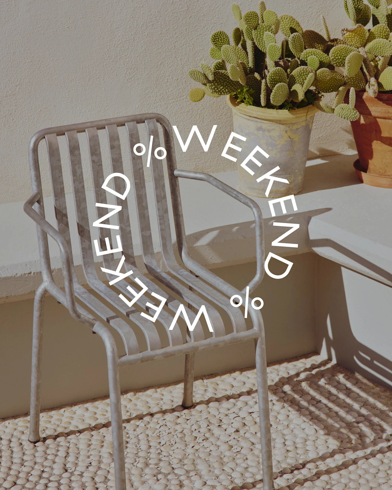 Grey metal slatted chair next to a potted cactus plant, with circular text 'WEEKEND % WEEKEND %' overlaid.